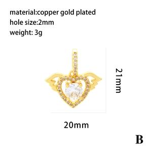 Detailed view of a gold-plated heart pendant with wings and sparkling clear crystals