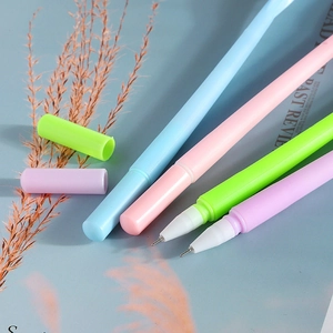 Flat lay of four colorful rose-topped gel pens with matte finish on blue background