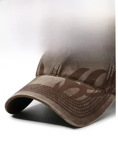 Close-up of vintage washed brown cotton baseball cap with white 3D letter H embroidery