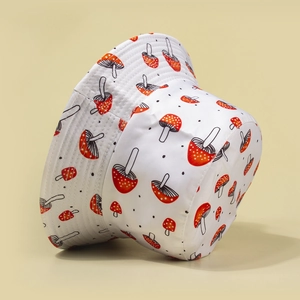 White bucket hat featuring red mushroom prints and black polka dots for outdoor fashion