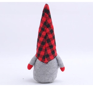 Detailed view of Christmas gnome featuring red and black plaid hat and soft felt texture