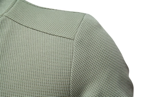 Detailed close-up of men's green stand collar jacket featuring waffle weave fabric texture