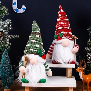Detail of Christmas gnomes with knitted hats and wooden skis in red and green festive colors