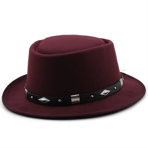 Detail of burgundy felt bowler hat with black leather band and silver metal studs