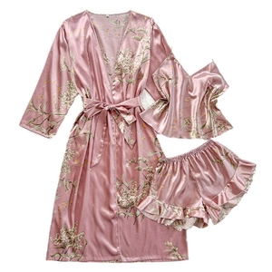 Three-piece pink floral satin loungewear set with belted robe, camisole and ruffled shorts