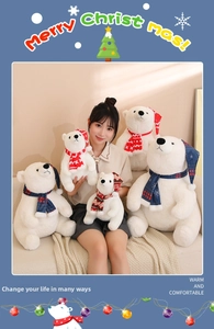Detail showing multiple sizes of Christmas polar bear plush toys with festive red blue scarves