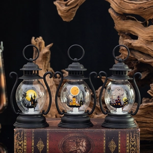 Three glowing Halloween LED lanterns with witch, pumpkin, and ghost silhouettes on vintage book