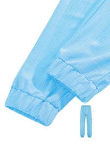 Detailed macro view of light blue cargo pants featuring woven waffle texture and elastic cuff