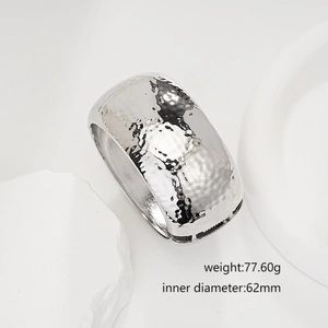 Detailed view of silver hammered texture wide bangle bracelet with minimalist aesthetic