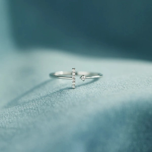 Macro detail of S925 sterling silver T-shaped ring with pavé and single zircon accents