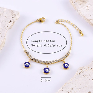 Golden titanium steel bracelet featuring zircon stars and blue evil eye enamel pendants