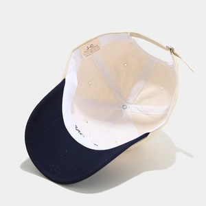 Detail view of cotton baseball cap interior showing 100% cotton label and sweatband