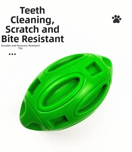 Close-up of green rubber football dog toy featuring durable molar cleaning textures