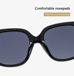 Detail shot of sunglasses featuring comfortable integrated nose pads and sleek black frames