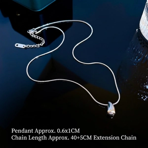 Macro detail of silver-tone teardrop pendant with adjustable snake chain necklace