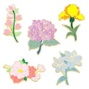 Five floral enamel pins in colorful lily and violet designs with gold metal plating
