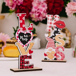 Detail of wooden LOVE and KISS signs with gnomes and heart patterns for Valentine decor