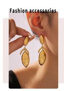 Detail of 18k gold plated geometric earrings worn, showing the high-shine mirror finish