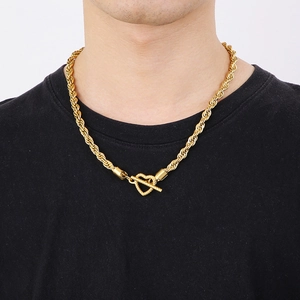 Close-up of golden twist rope chain necklace with heart-shaped OT toggle clasp on male neck