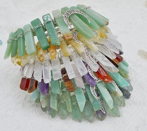 Macro shot of assorted natural crystal stones hand-wrapped on bohemian moon headbands