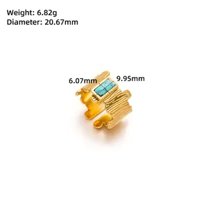 Detail of golden adjustable ring featuring bark texture and blue turquoise inlay