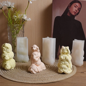 Macro view of stacked sheep and frog silicone molds for animal candles and ornaments