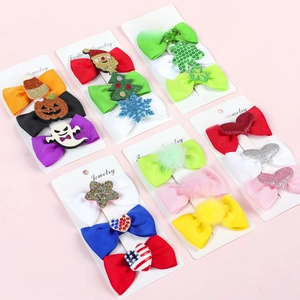 Three-piece festive hair bow clips set with holiday motifs on branded cards