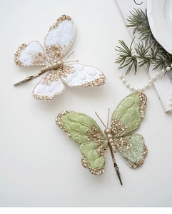 Detail of velvet butterfly clips with gold glitter and beads for Christmas tree decor