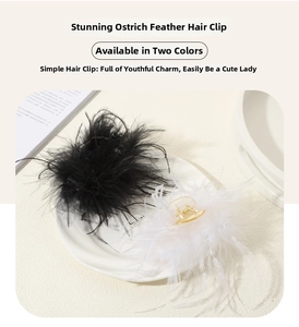 Detail shot of fluffy ostrich feather hair claws in black and white on a tray