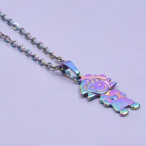 Macro detail of a girl shaped pendant with rainbow metallic finish on a fine steel chain