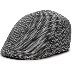 Close-up detail of the textured herringbone tweed fabric and stitching on the newsboy cap