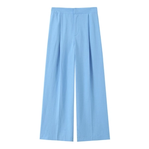 Detail of light blue high-waisted wide-leg trousers with elegant waist pleats