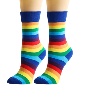 Detail of colorful rainbow striped crew socks with elastic ribbed cuffs on a model
