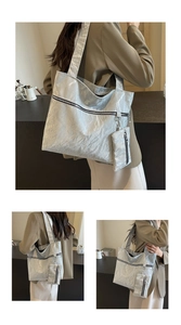 Detail of silver metallic tote bag with wrinkled texture and mini detachable pouch