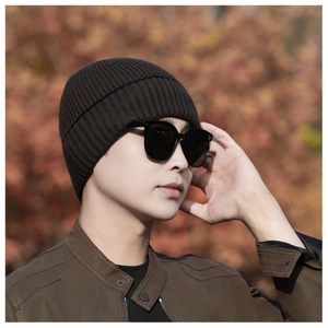 Close-up of thick ribbed knit texture and cuffed hem on a winter beanie hat
