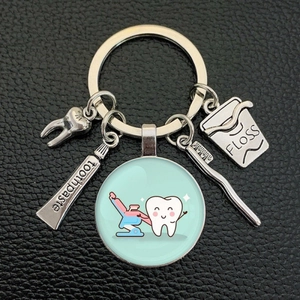 Creative dental keychain with cartoon tooth, toothpaste, toothbrush and floss charms