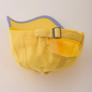 Back view of yellow cotton kids baseball cap with adjustable metal buckle and blue trim