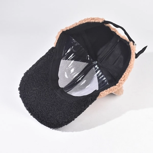 Detail view of khaki lamb wool baseball cap with black brim and adjustable back strap