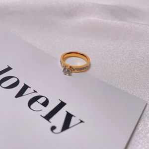 Elegant gold titanium steel ring with round zircon main stone and pave diamond accents