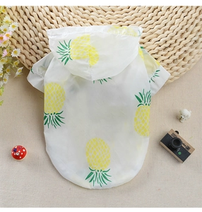 Detailed close-up of a white pet sun protection hoodie with vibrant yellow pineapple patterns