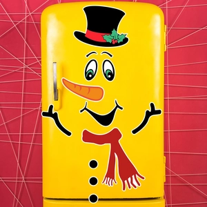 Detail of Christmas snowman magnetic stickers applied on a yellow retro refrigerator door