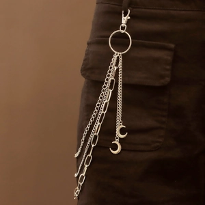 Close-up of a silver multi-layered punk waist chain with metal crescent moon pendants