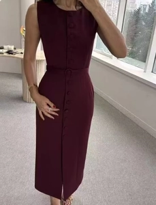 Detail of burgundy sleeveless dress featuring single-breasted buttons and matching waist belt