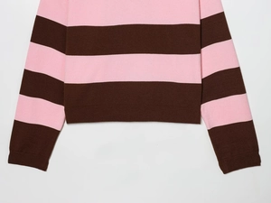 Detail of pink and brown striped knit sweater showing hemline and textured fabric