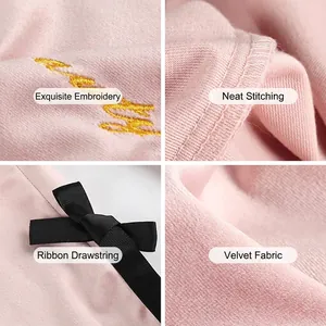Pink velvet drawstring storage bag with golden embroidery and elegant ribbon handle