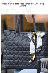 Close-up of black tote bag with heart-shaped quilting and elegant patterned silk scarf handle
