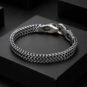 Macro shot of 316L stainless steel woven bracelet with detailed dragon head clasp