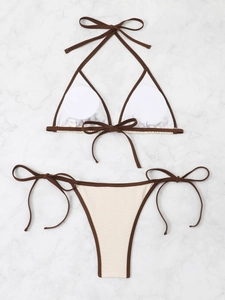 Detailed flat lay of beige and brown bikini with neck ties and soft padding inserts