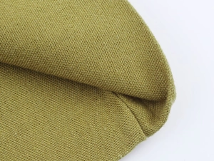 Macro shot of olive linen fabric texture showing high-density knitting craftsmanship