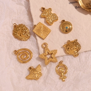 Flat lay of vintage gold-plated stainless steel charms with lion, bear, and star designs